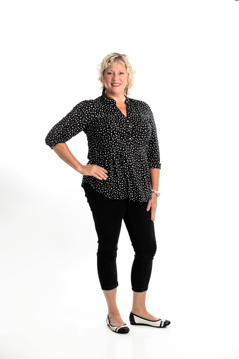 Debbie Kaminski standing in a white studio